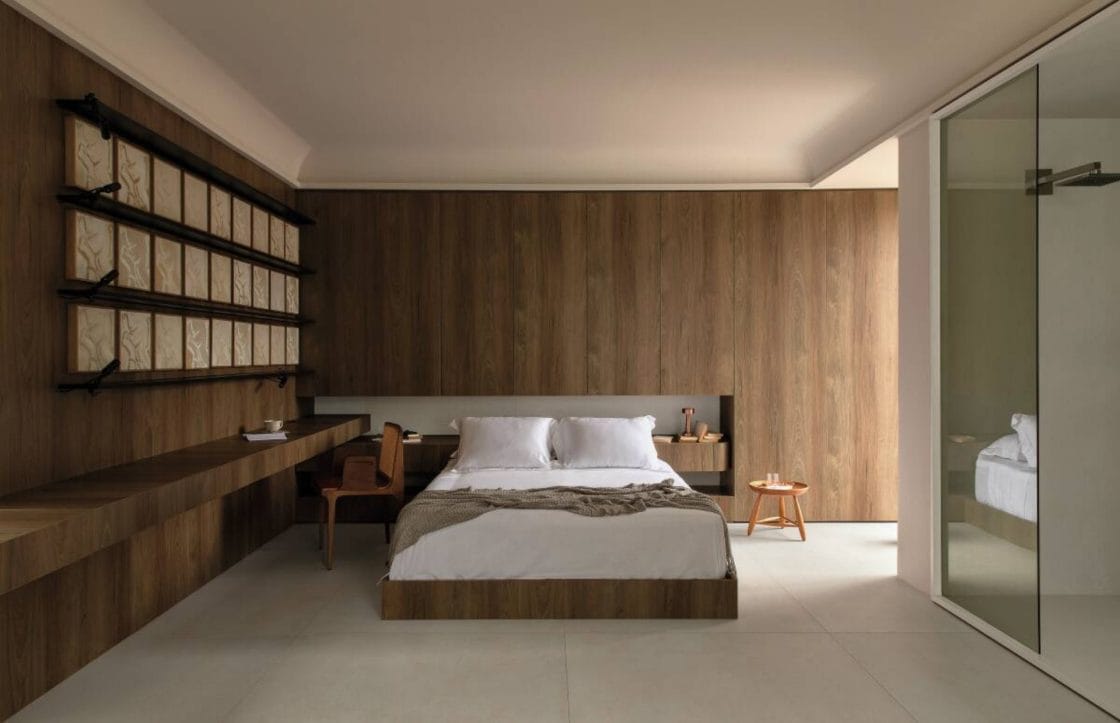 Quarto home office com revestimentos em madeira, neutro, e bancada de madeira (Projeto: Portobello)